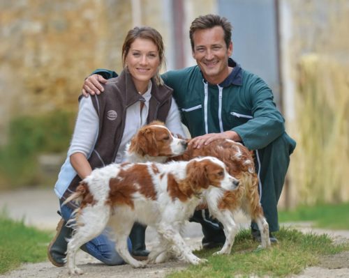 A woman and a man with 2 dogs